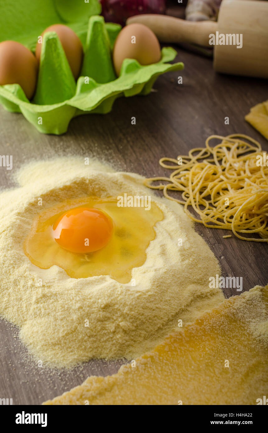Homemade spaghetti carbonara with semolina - production, pasta machine Stock Photo