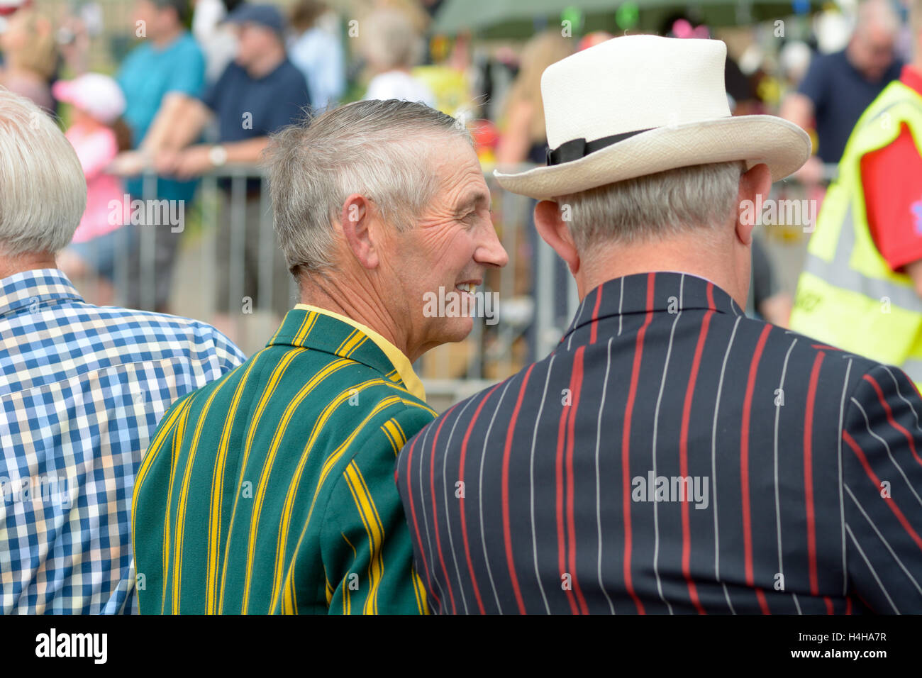 Men looking dapper in striped blazers watching parade at the River Festival in Bedford, Bedfordshire, England Stock Photo