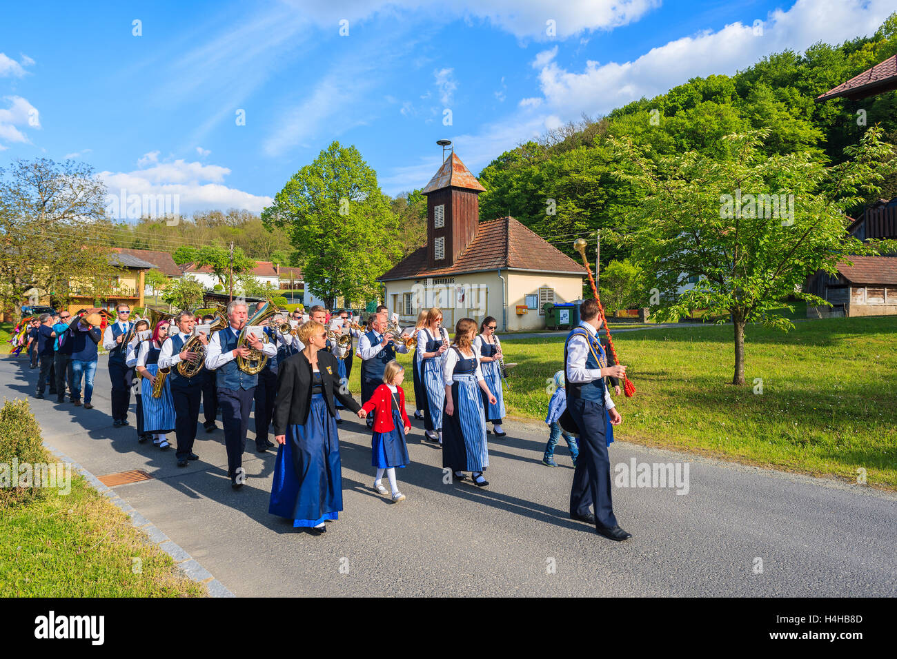 GLASING VILLAGE, AUSTRIA - APR 30, 2016: music band people walking in a parade on street during May Tree celebration. In Germany Stock Photo