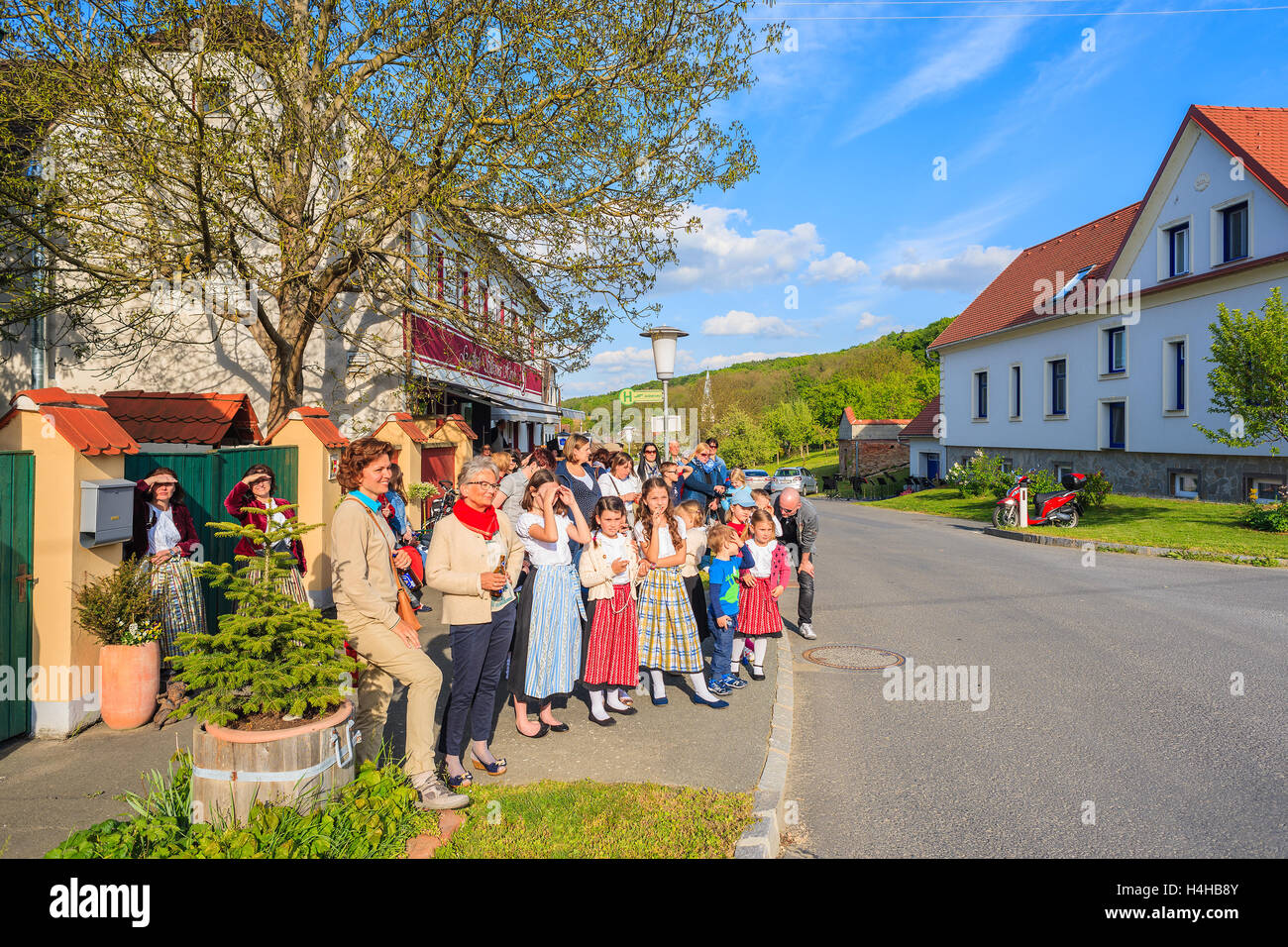 GLASING VILLAGE, AUSTRIA - APR 30, 2016: people watching dancing on street during May Tree celebration. In Germany and Austria t Stock Photo