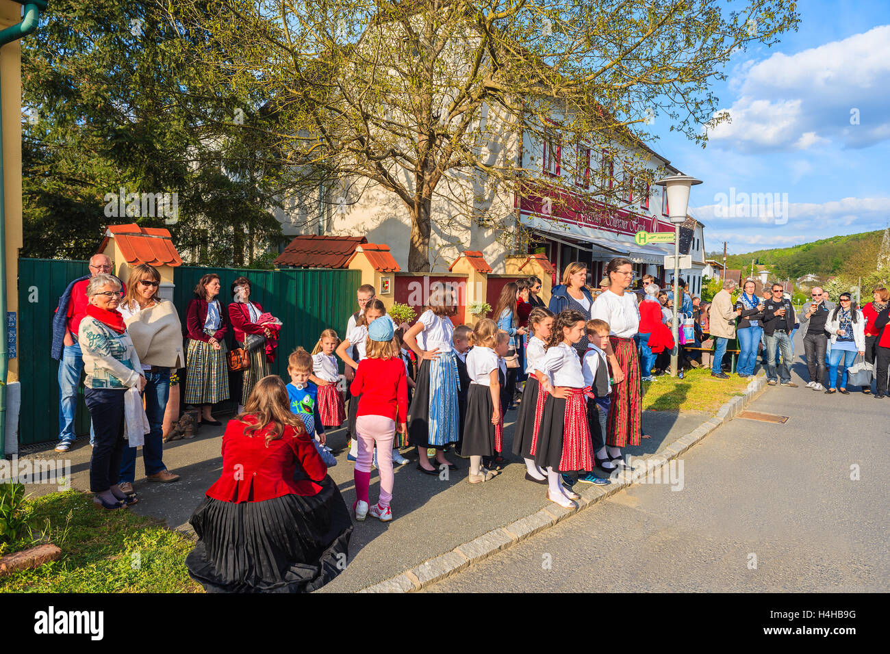 GLASING VILLAGE, AUSTRIA - APR 30, 2016: people watching dancing on street during May Tree celebration. In Germany and Austria t Stock Photo