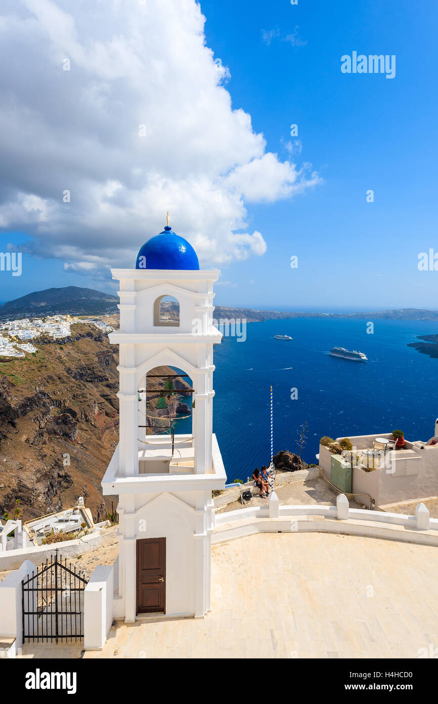 White church with blue dome in Imerovigli village and sea in background, Santorini island, Greece Stock Photo