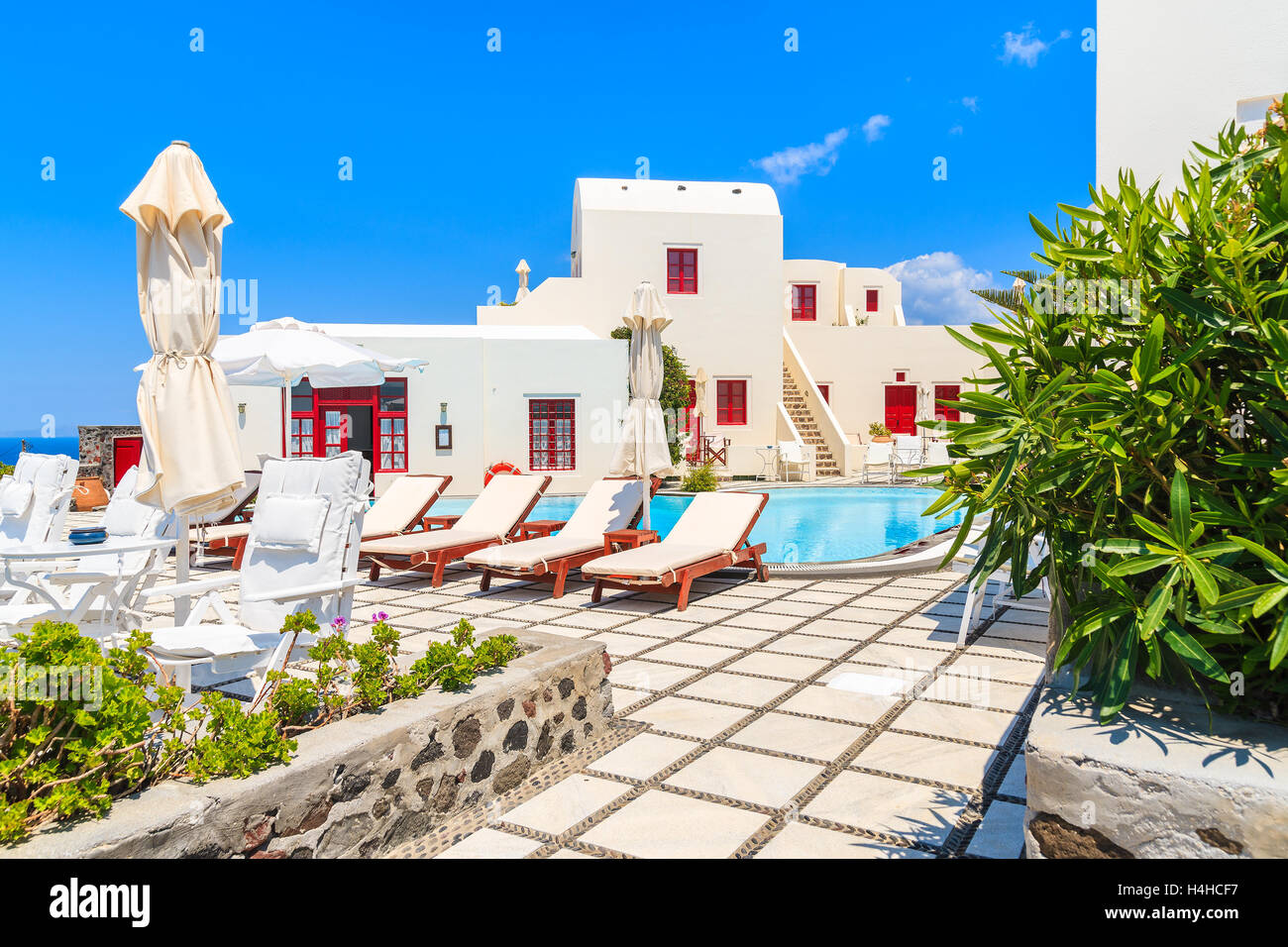 OIA VILLAGE, SANTORINI ISLAND - MAY 23, 2016: Typical greek style apartment hotel with pool in Oia village, Santorini island, Gr Stock Photo
