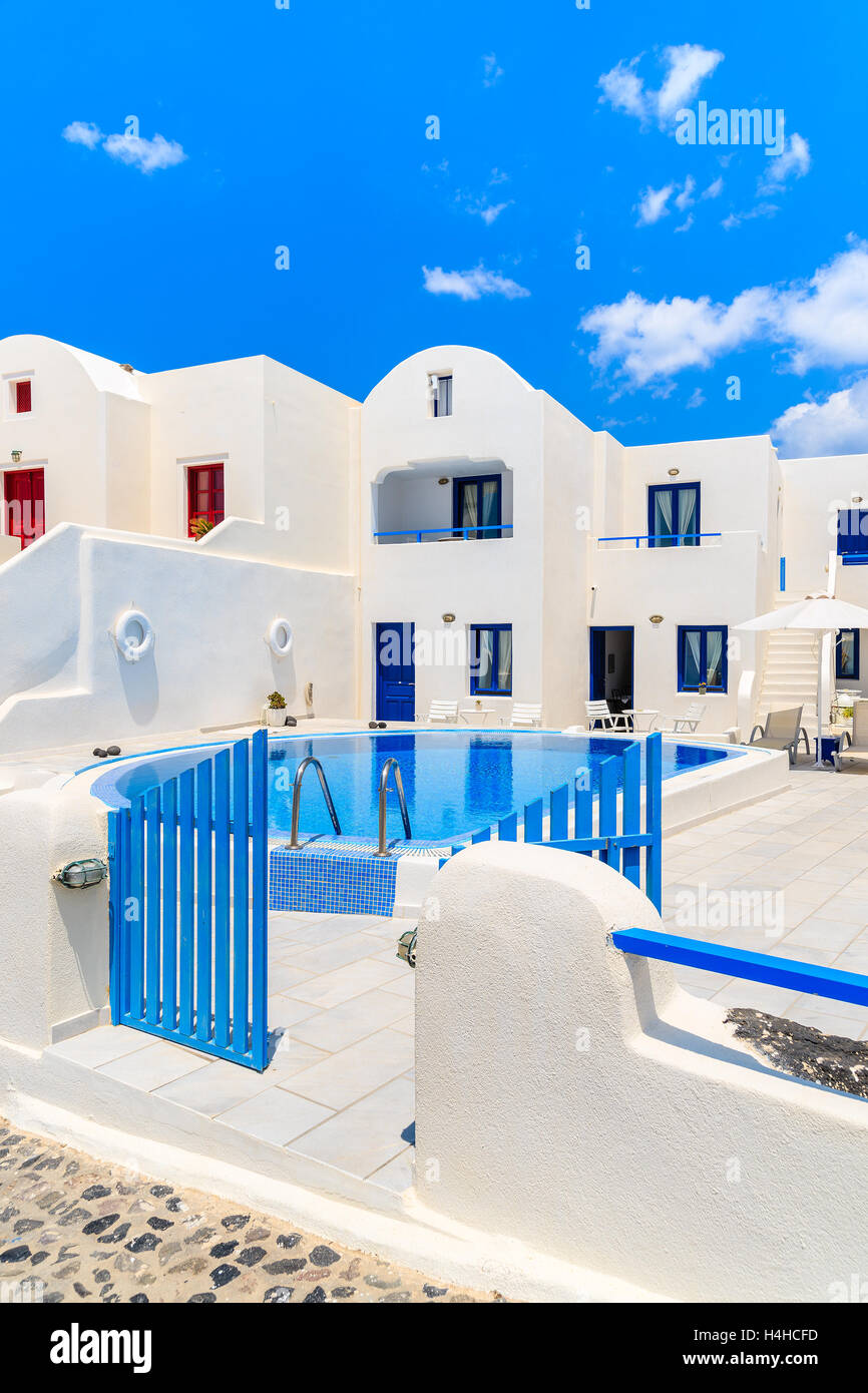 OIA VILLAGE, SANTORINI ISLAND - MAY 23, 2016: Typical greek style apartment hotel with pool in Oia village, Santorini island, Gr Stock Photo