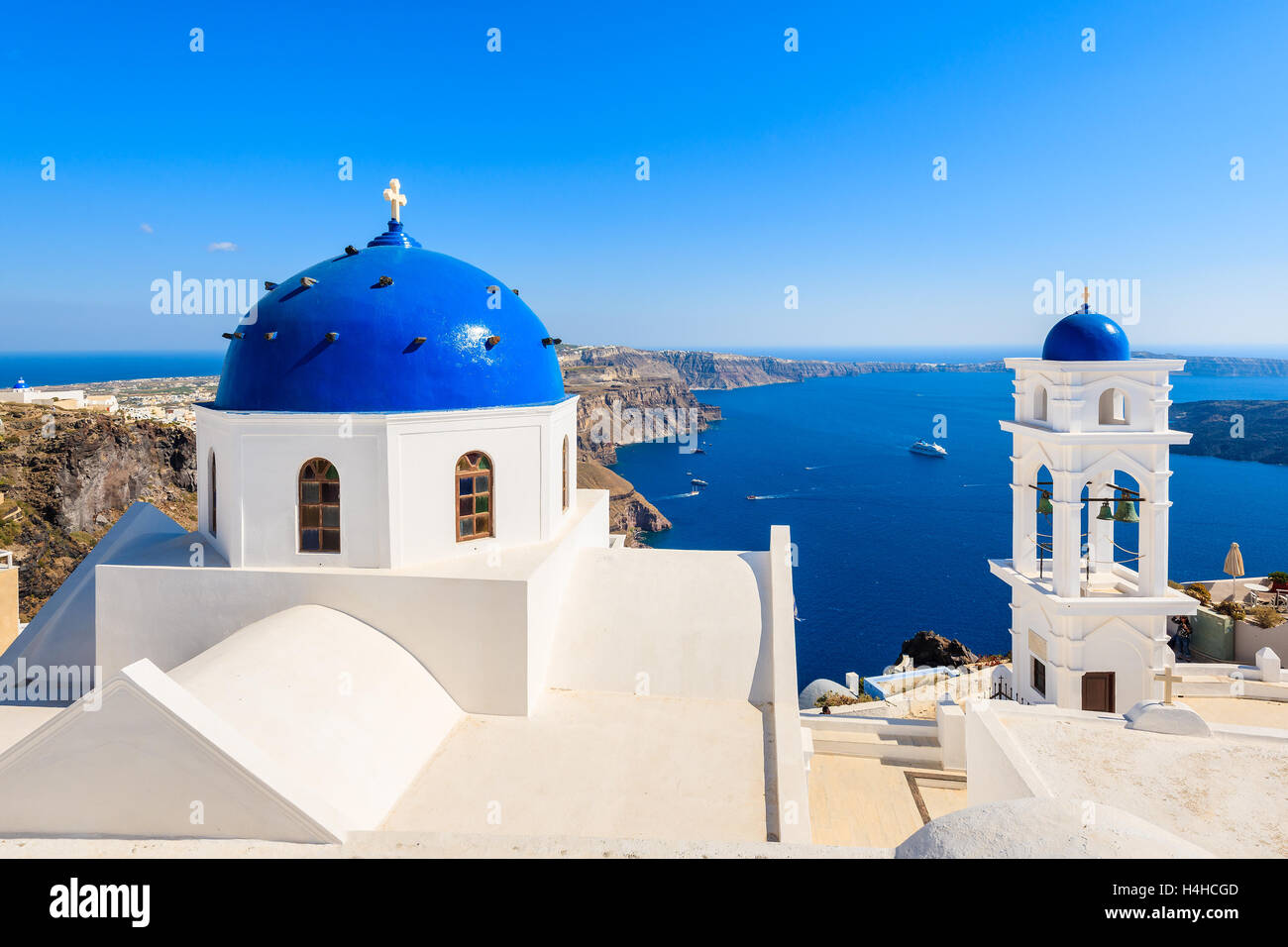 Blue dome of church in Imerovigli village and view of blue sea with ...