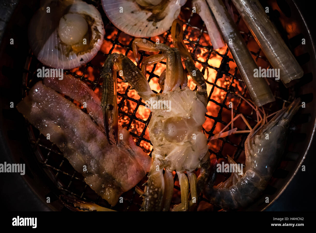 Barbecue grilled crab seafood cooking on hot flaming grill Stock Photo