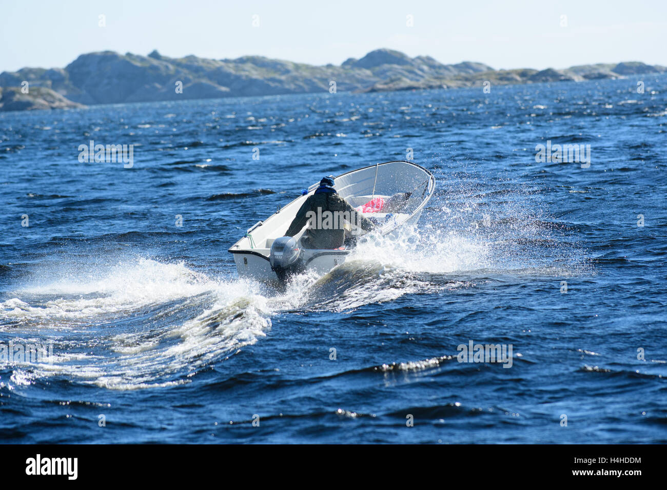 Small boat on the waves with splashing water, Mandal, Norway Stock Photo