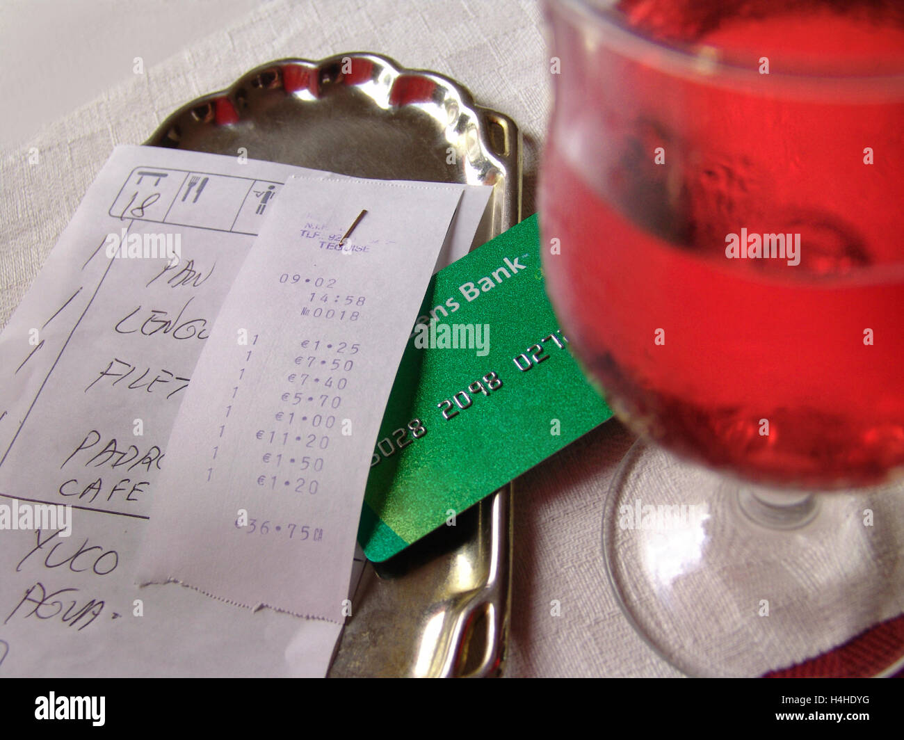 Rose wine glass on typical restaurant table with bank debit/credit card