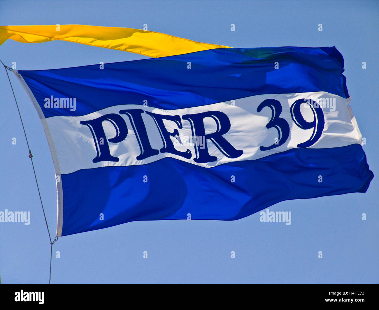 Pier 39 Flag flutters in the breeze at the Embarcadero San Francisco California USA Stock Photo