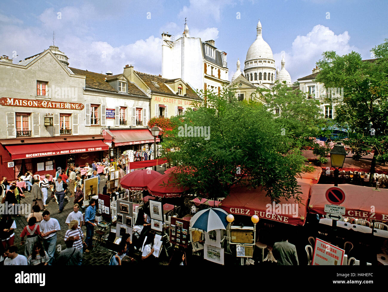 Elevated view from Chez Eugene restaurant balcony on Place du Tertre with Sacré Coeur cathedral beyond. Montmartre, Paris, France Stock Photo