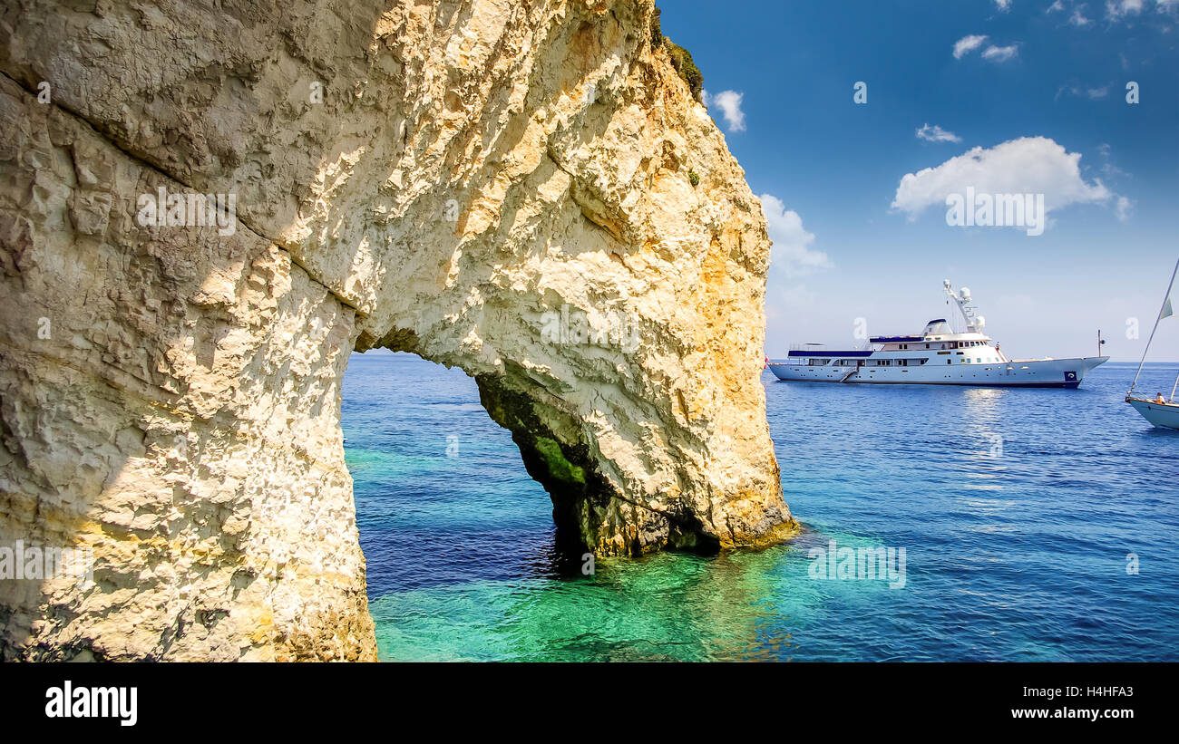 Blue caves on Zakynthos island, Greece. Famous blue caves view on Zante. Tourists visiting the caves by boat. Stock Photo