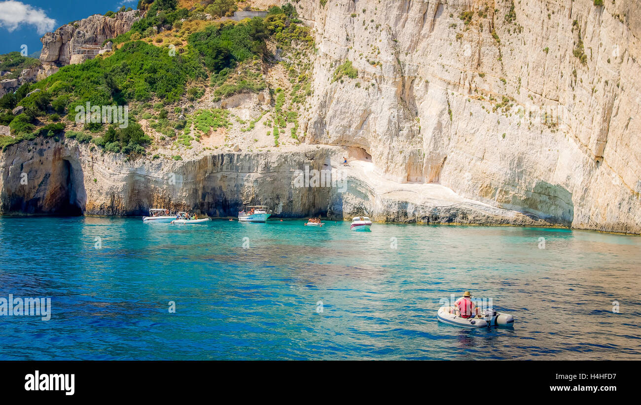 Blue caves on Zakynthos island, Greece. Famous blue caves view on Zante. Tourists visiting the caves by boat. Stock Photo