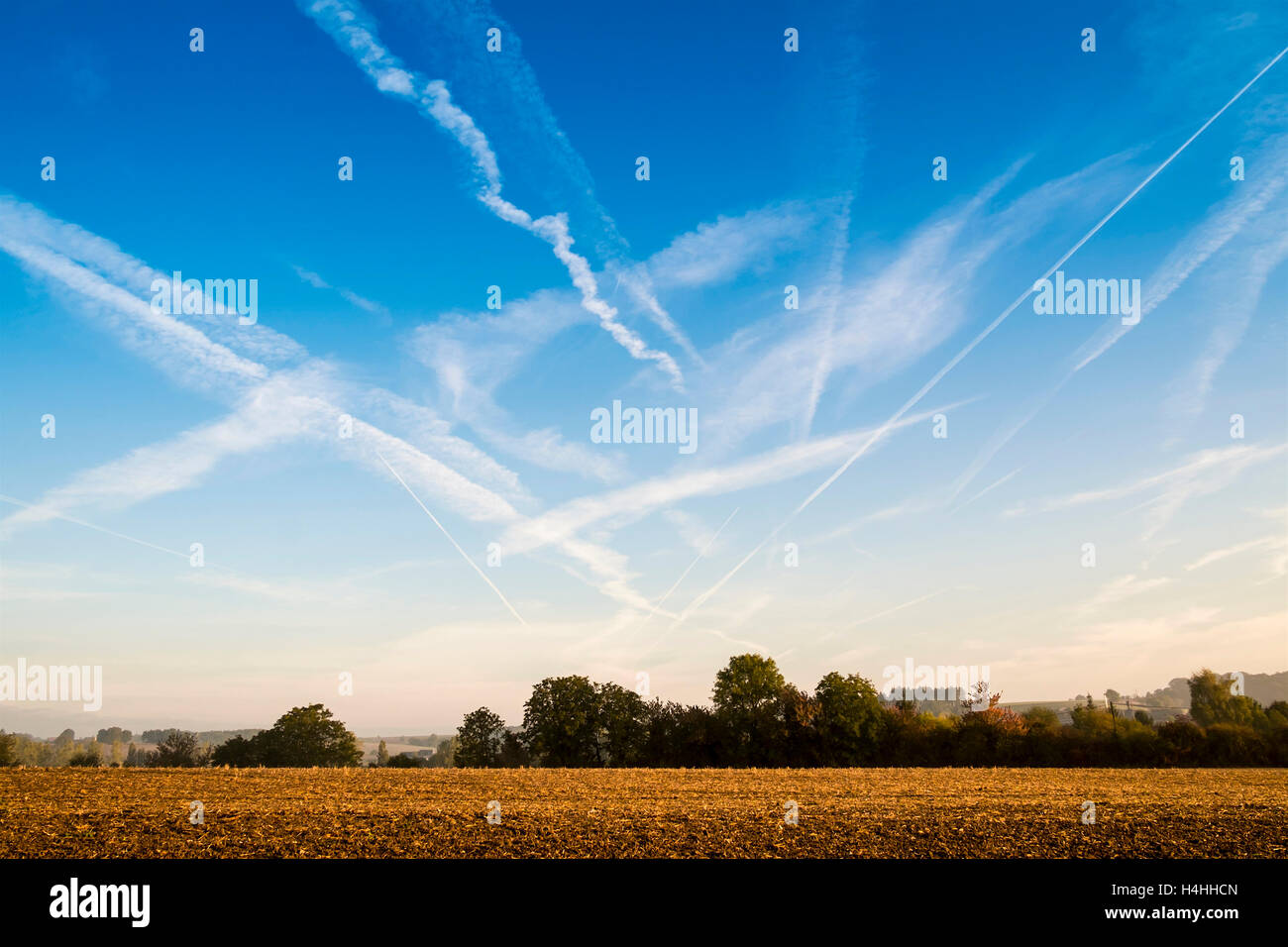 Blue skyscape with contrails or chemtrails - France. Stock Photo