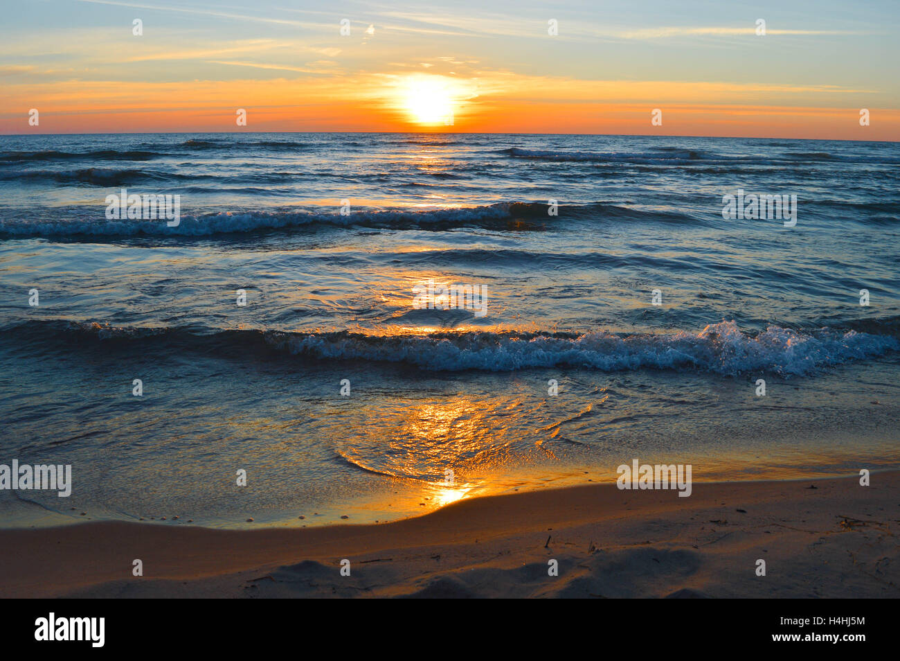 Brilliant sunrise on the waters of Lake Huron at the pier in Oscoda, Michigan Stock Photo