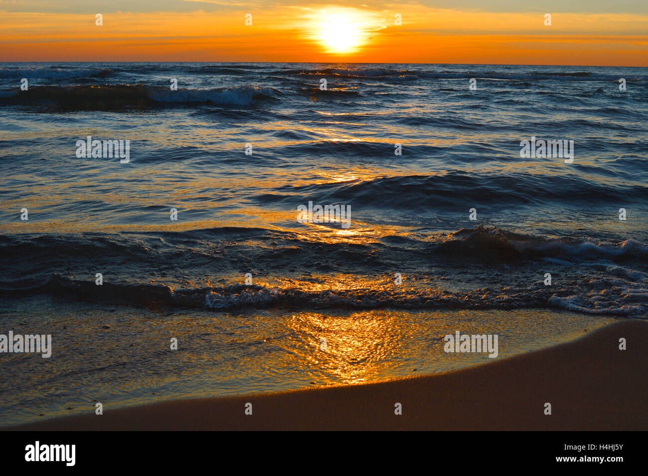 Brilliant sunrise on the waters of Lake Huron at the pier in Oscoda, Michigan Stock Photo