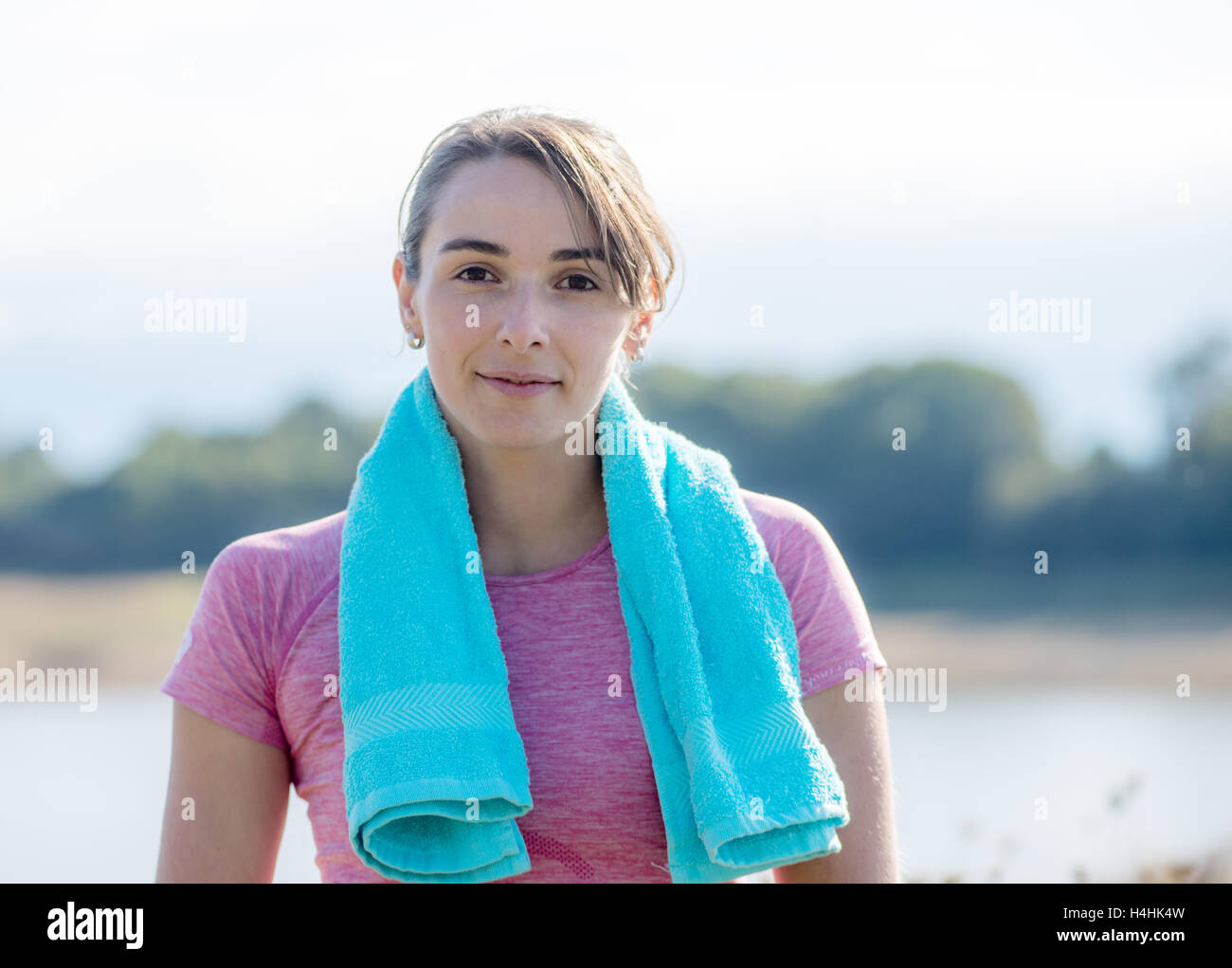 portrait of young sporty woman with blue towel in the countryside Stock ...