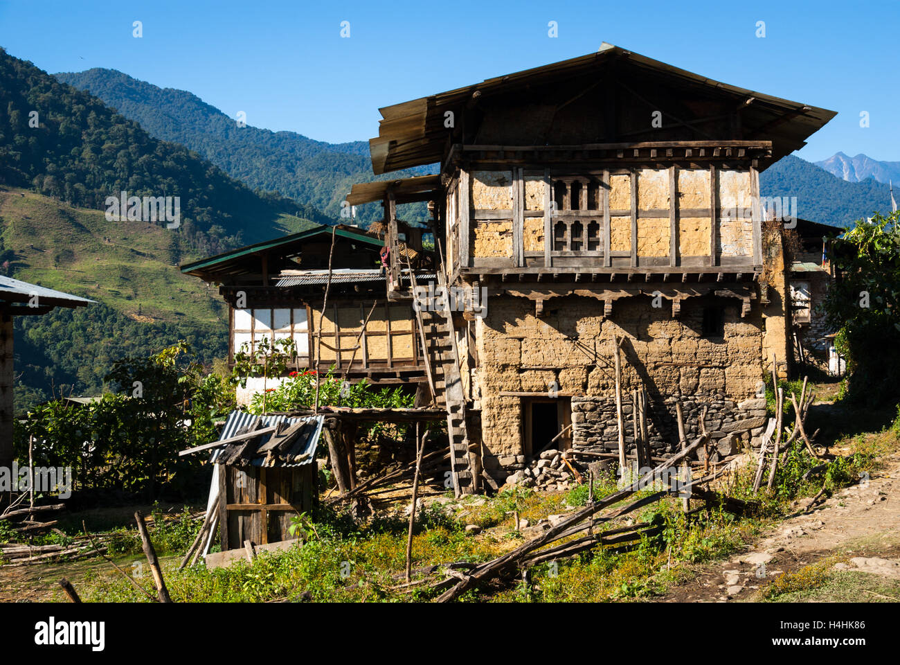 Traditional rammed-earth and wood houses in remote Nabji Village, which lies in the hills south of Trongsa, Bhutan Stock Photo