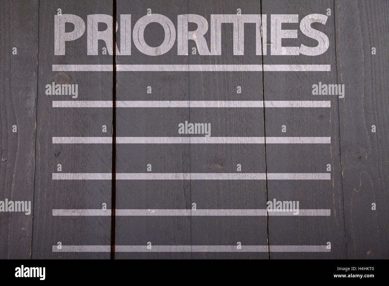 Priorities list on black wooden background Stock Photo