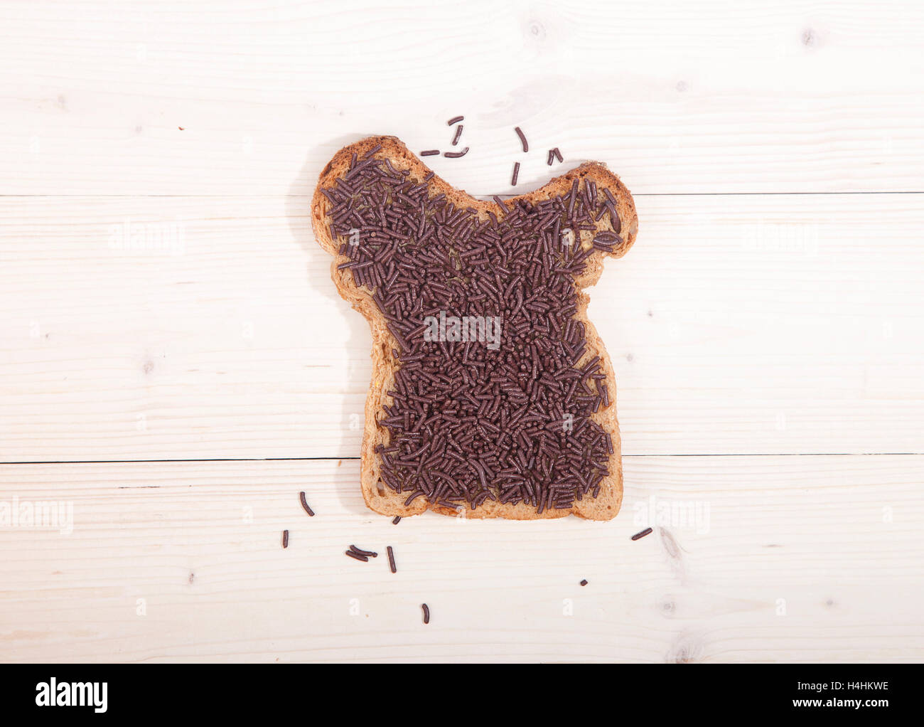Typical Dutch bread with chocolate hagelslag on wooden background Stock Photo