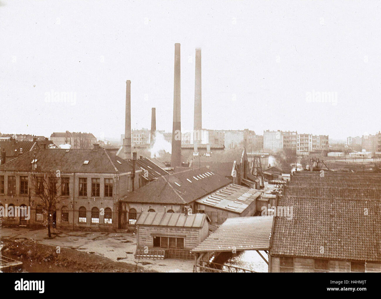 Exterior of factory buildings with chimneys, Anonymous Stock Photo