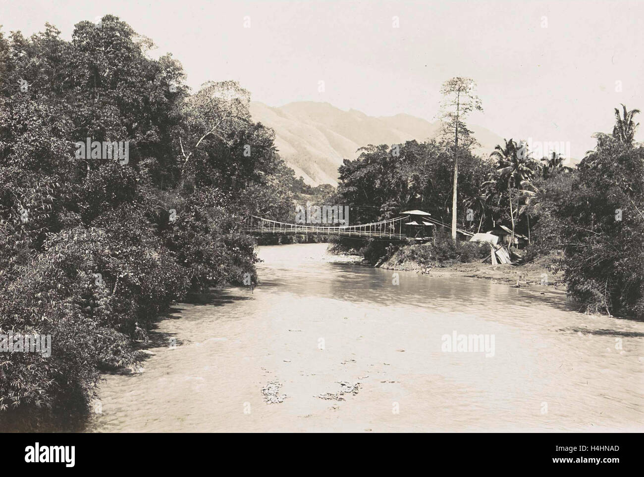 Dutch East Indies, indonesia, river Godang with suspension bridge, Anonymous, 1900 - 1930 Stock Photo