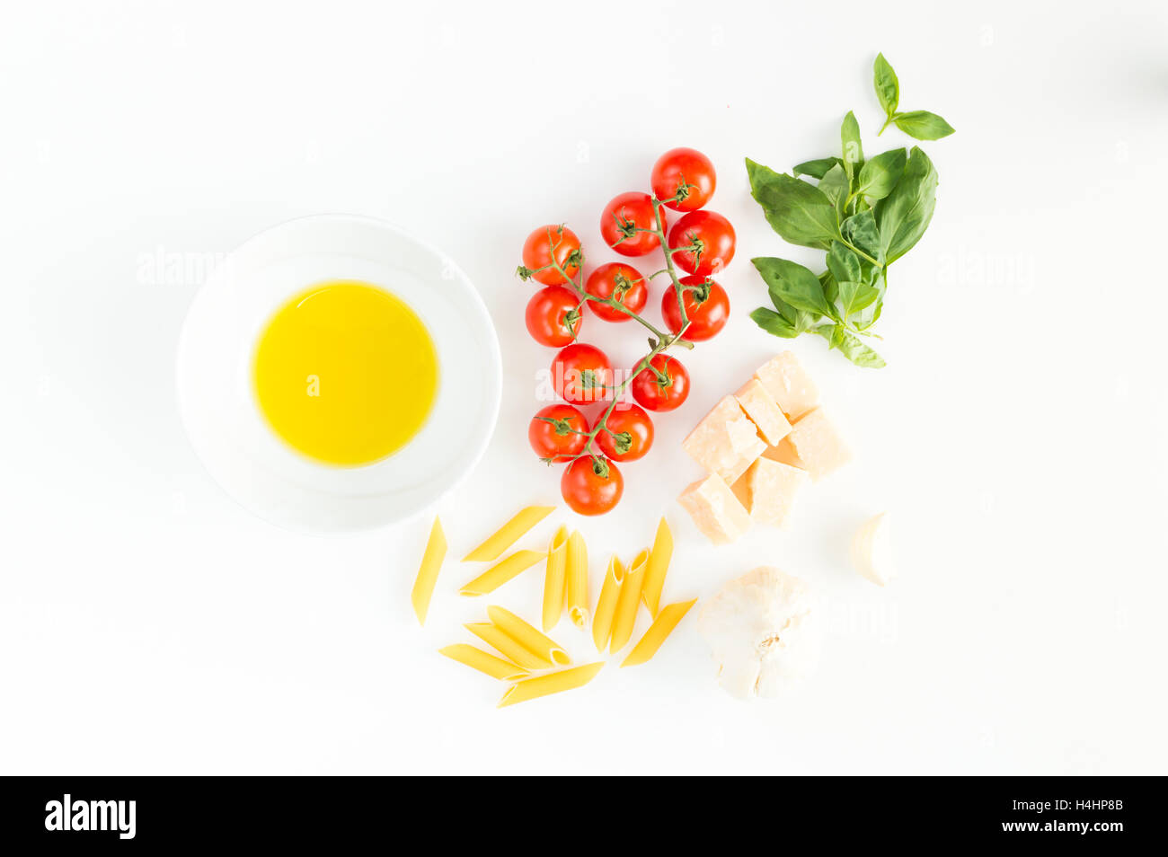 Italian red tomatoes close up food with pasta, basil leafs, cheese, isolated on white background - Flat lay Stock Photo