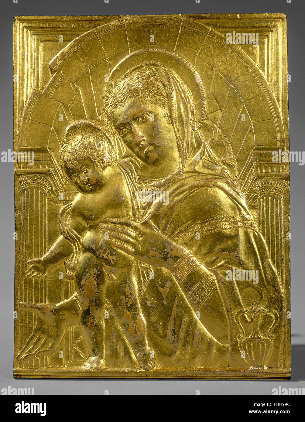 Follower of Donatello, Madonna and Child within an Arch, mid 15th century, gilt bronze Stock Photo