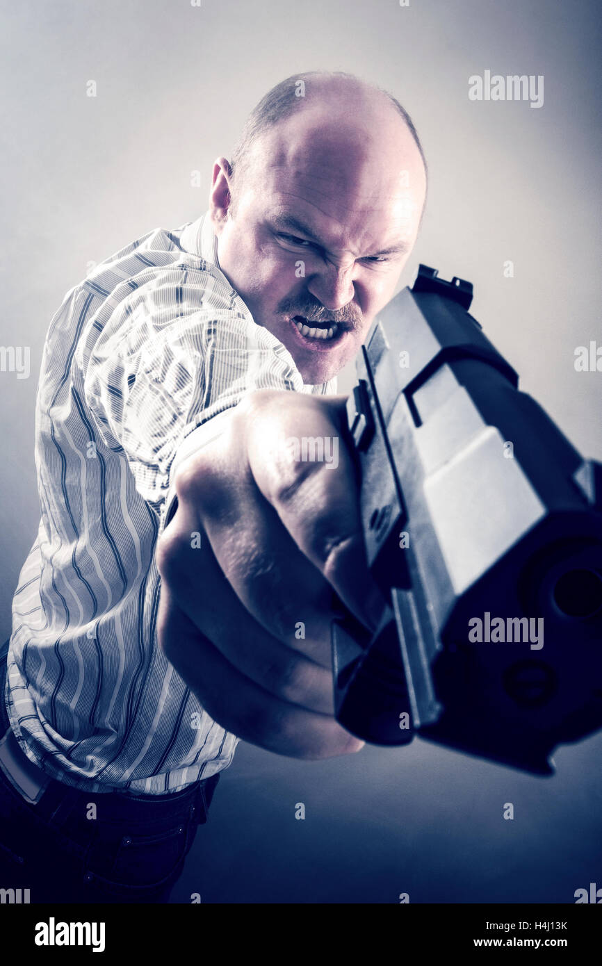Frustrated Businessman Aiming Gun Stock Photo