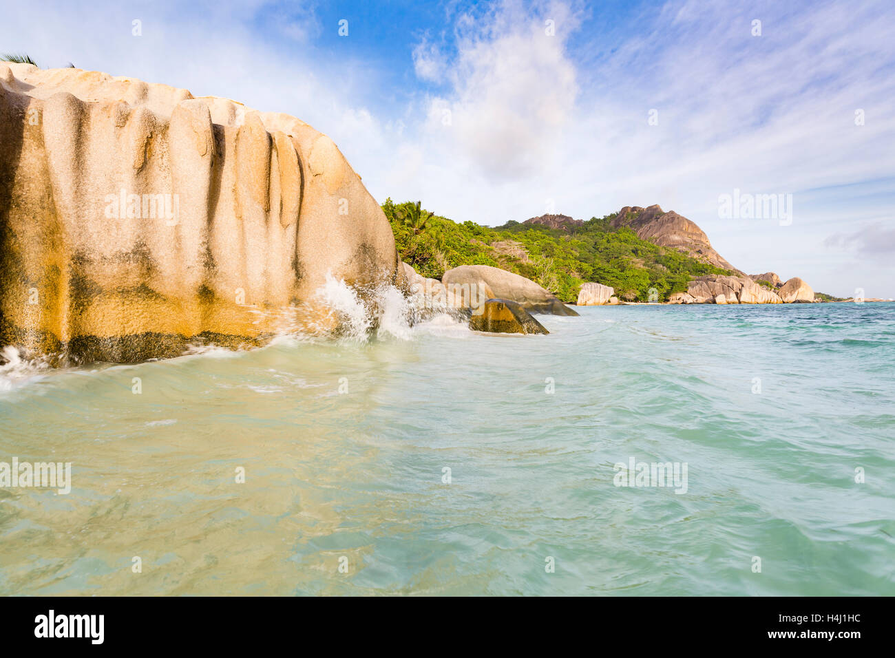 Waves splashing against granite rocks at Anse Source D'Argent in La Digue, Seychelles Stock Photo