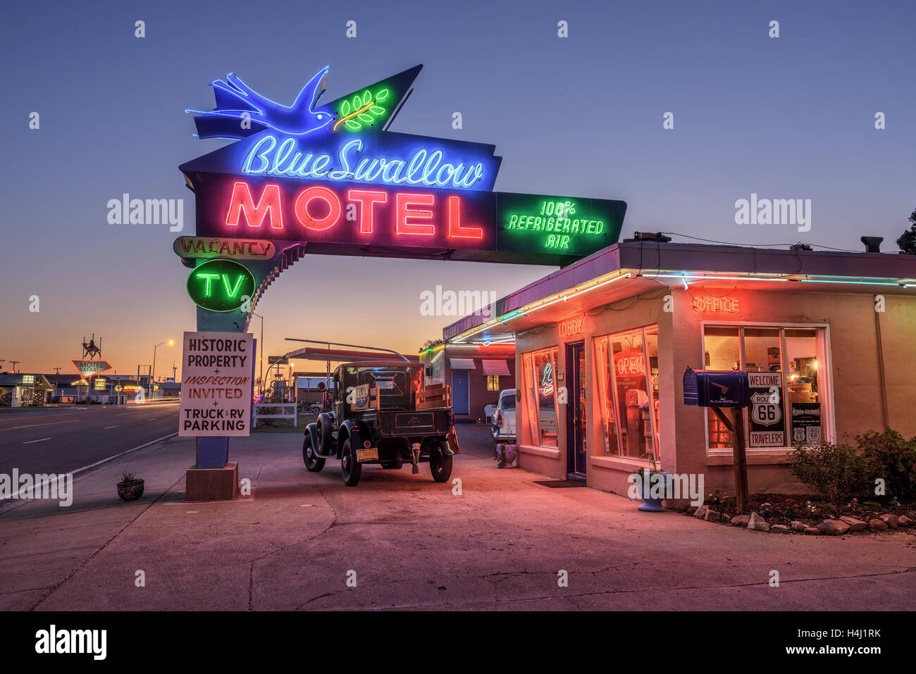 Historic Blue Swallow Motel with a vintage car parked in front of it during the blue hour Stock Photo