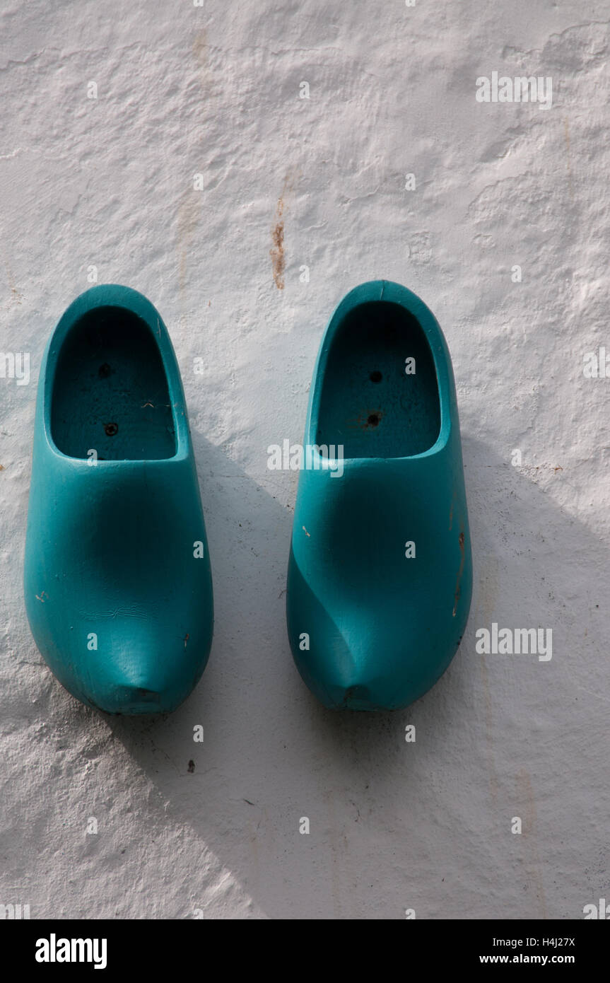 Wooden clogs on a wall Stock Photo