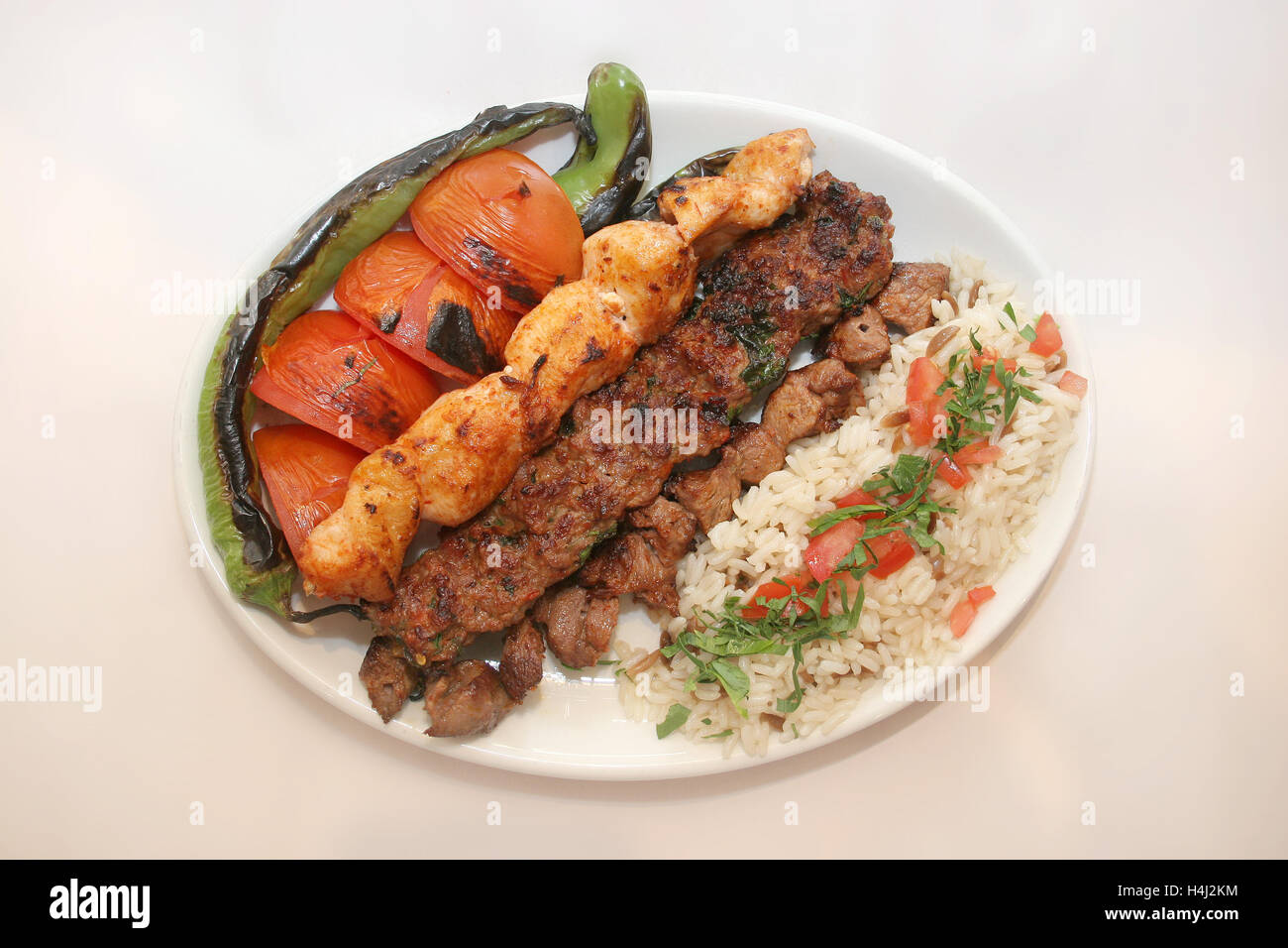 Chicken kebab, lamb kebab, kofta kebab served with rice and salad Stock