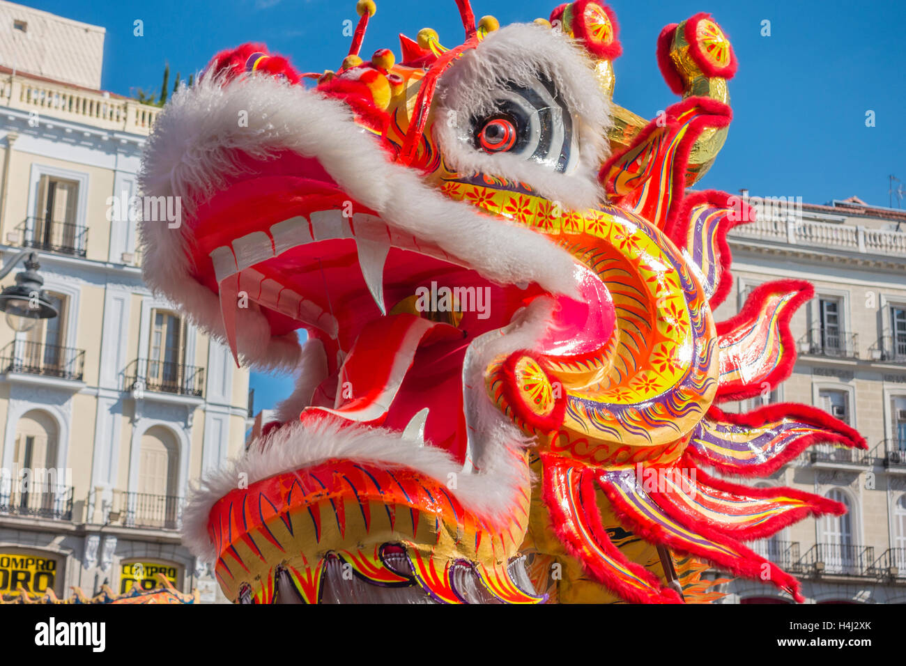 Close-up of dragon's head in the Chinese dragon dance in Puerta del Sol, Madrid, Spain. Stock Photo