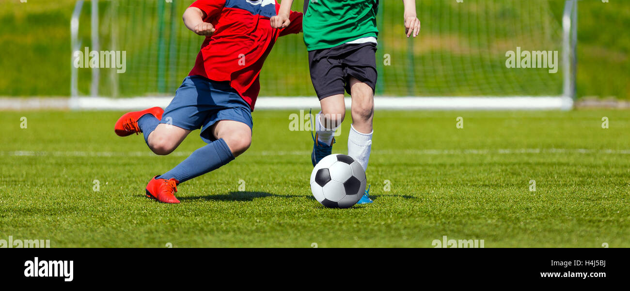 Boys kicking soccer ball. Youth soccer game for kids Stock Photo Alamy