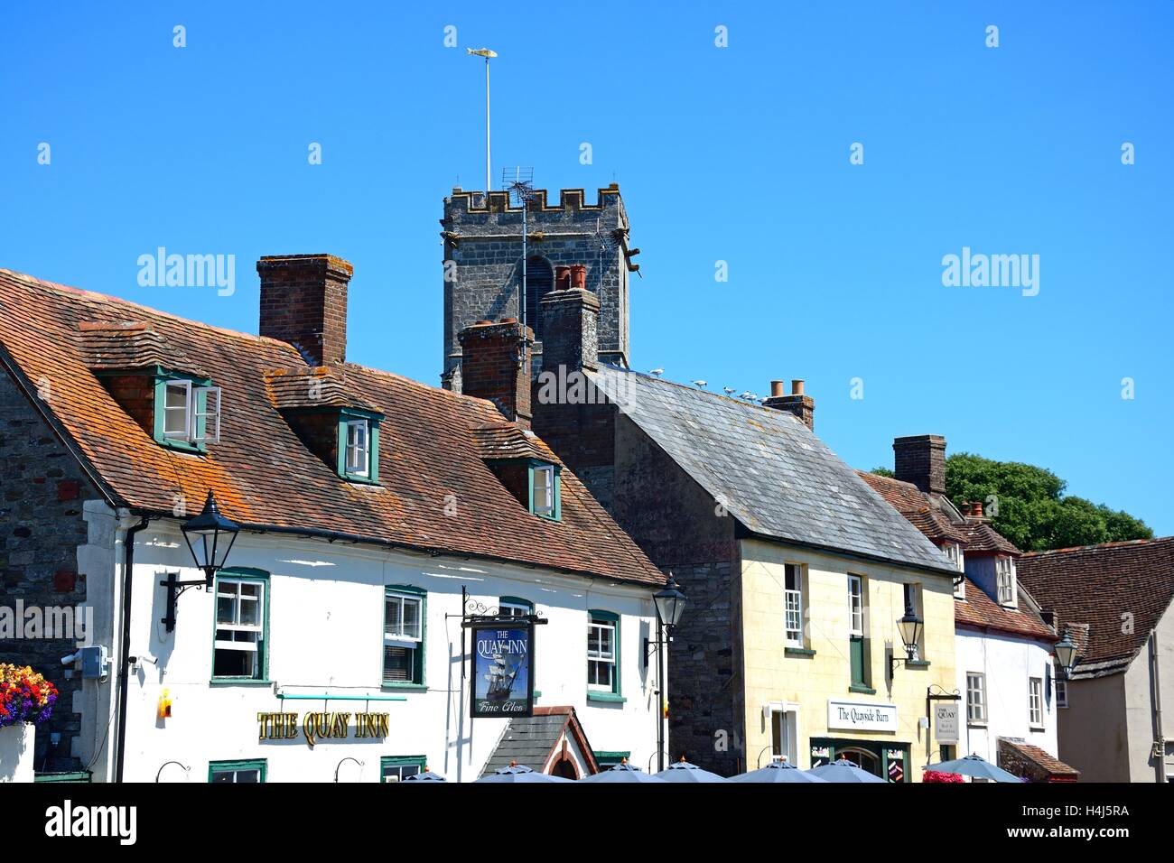 The Quay Inn pub and shops with Lady St Mary church tower to the rear