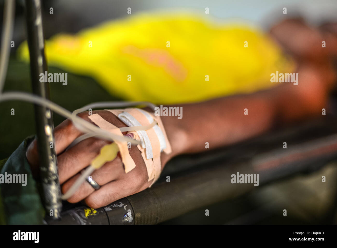 Aris, member of Indonesia U19 men team gets medical treatment after down river race category during the 2015 World Rafting Championships. Stock Photo