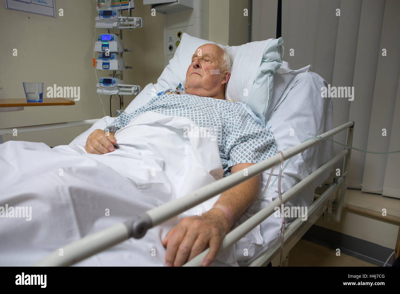 Elderly man (83) recovering in his hospital bed in the cardiac ward