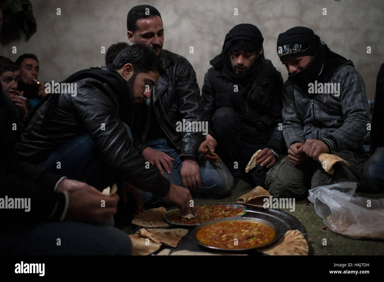 Lunch at the katiba -  11/02/2013  -  Syria / Aleppo / Al-Bab  -  Fighters of the  Abo Baker brigade ( Free Syrian Army) share a lunch during fightings against syrian governmental troops defending the Kwiriss military airport, in Al-Bab near Aleppo.   -  Edouard Elias / le Pictorium Stock Photo