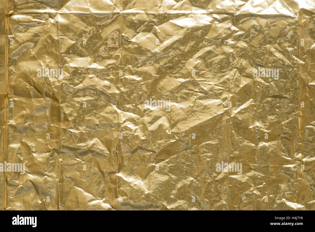 creased gold creased metallic foil background texture Stock Photo
