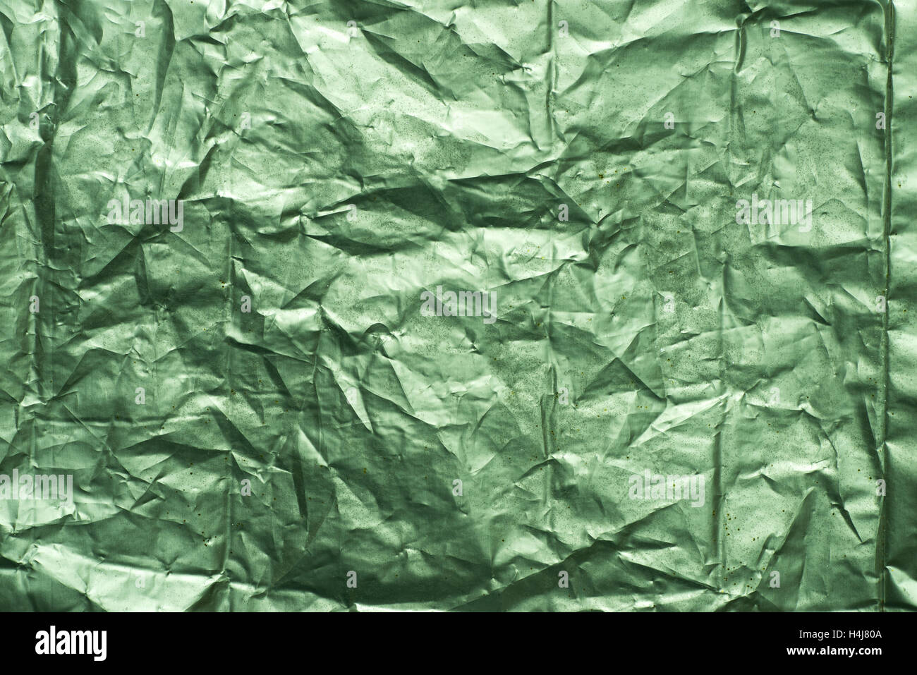 green weathered creased metallic foil background texture Stock Photo