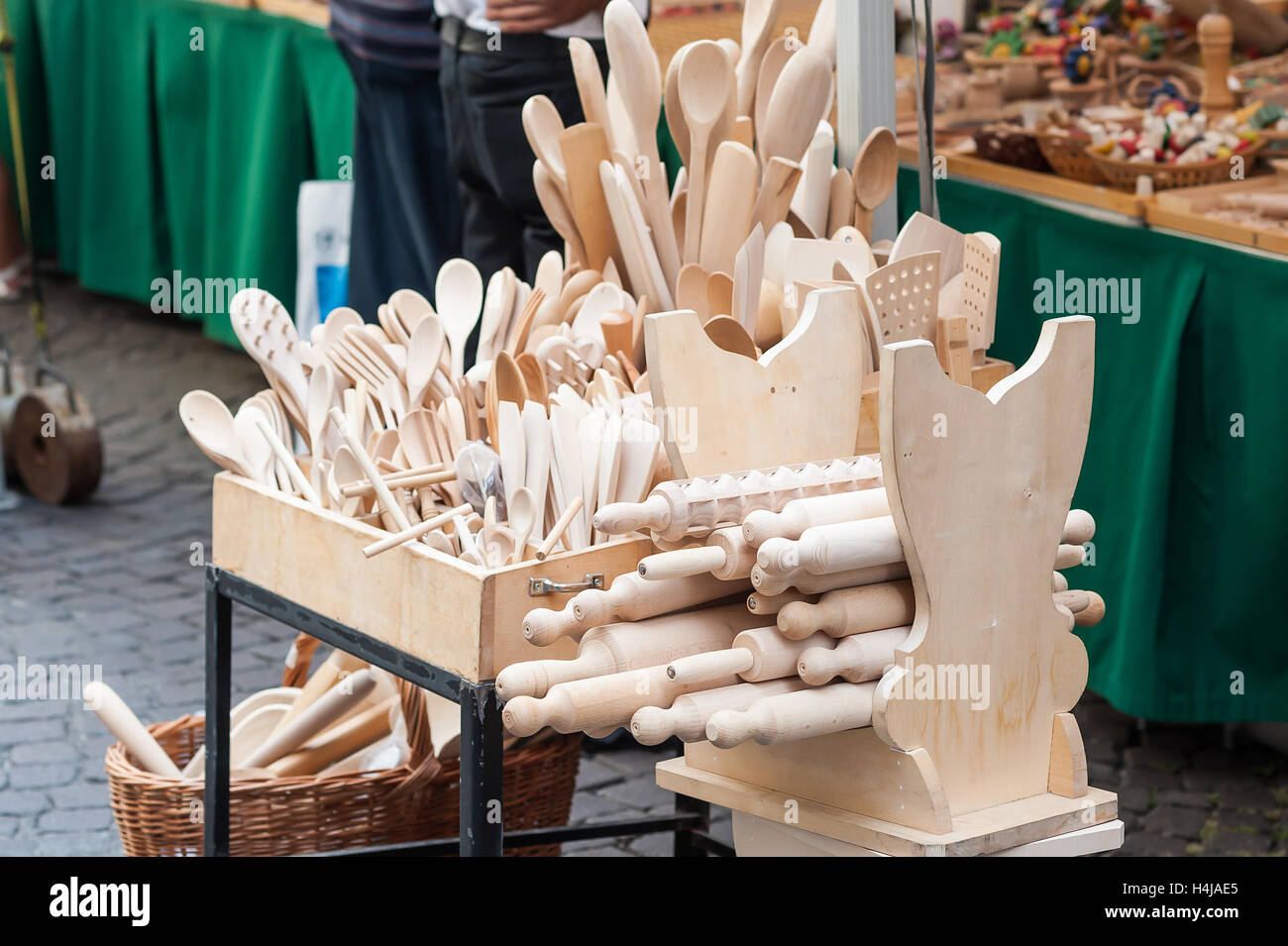 Handmade wooden, vintage kitchen utensils for sale at the market. Various wooden kitchen tools. Different wooden tableware. Stock Photo