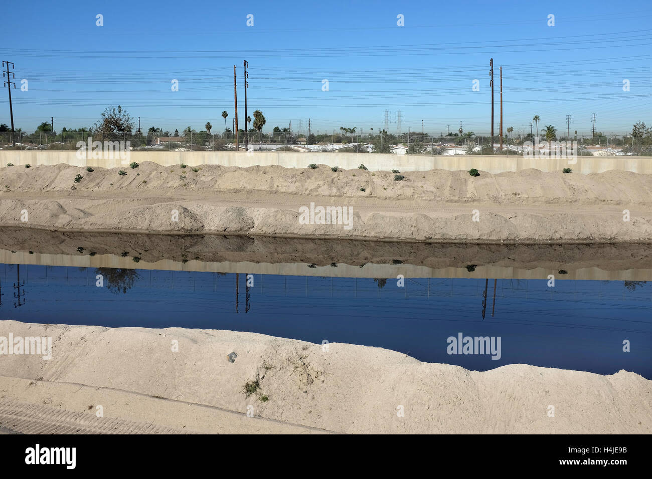 Santa Ana River is Orange County, California, Crews clean sand from the concrete lined water way. The sand is reclaimed. Stock Photo
