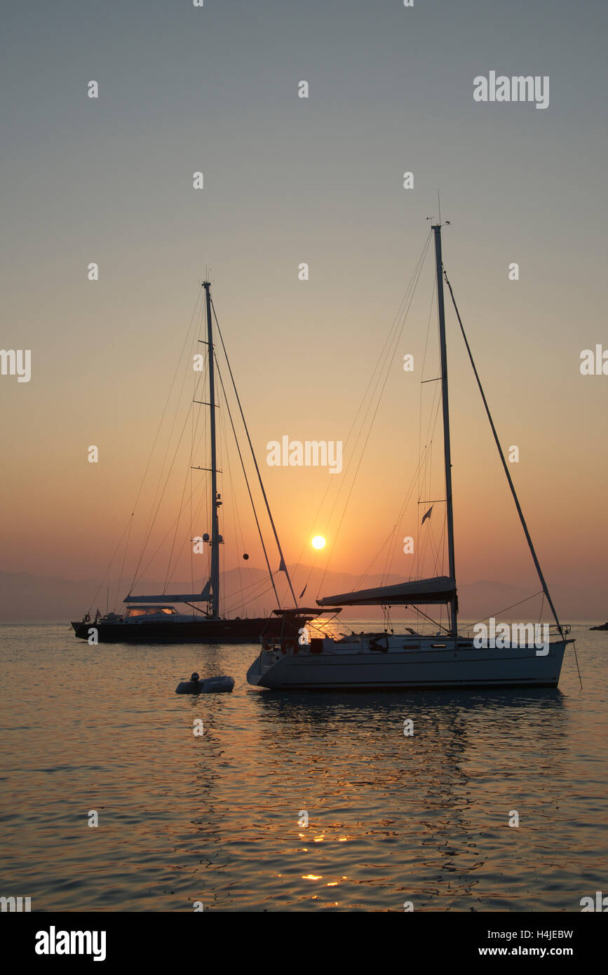 Two yachts in sunset Lakka Harbour Paxos Ionian Islands Greece Stock Photo