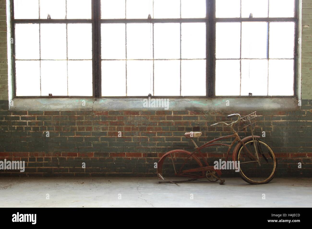 An antique bike in an abandoned warehouse Stock Photo