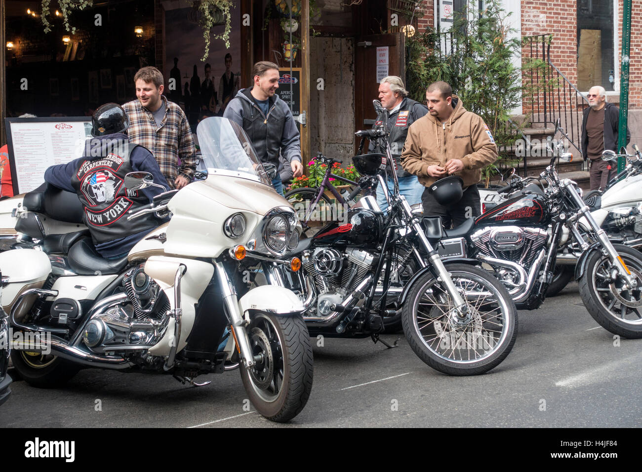 A Harley-Davidson motorcycle club parking their bikes outside a Little Italy restaurant in New York City Stock Photo