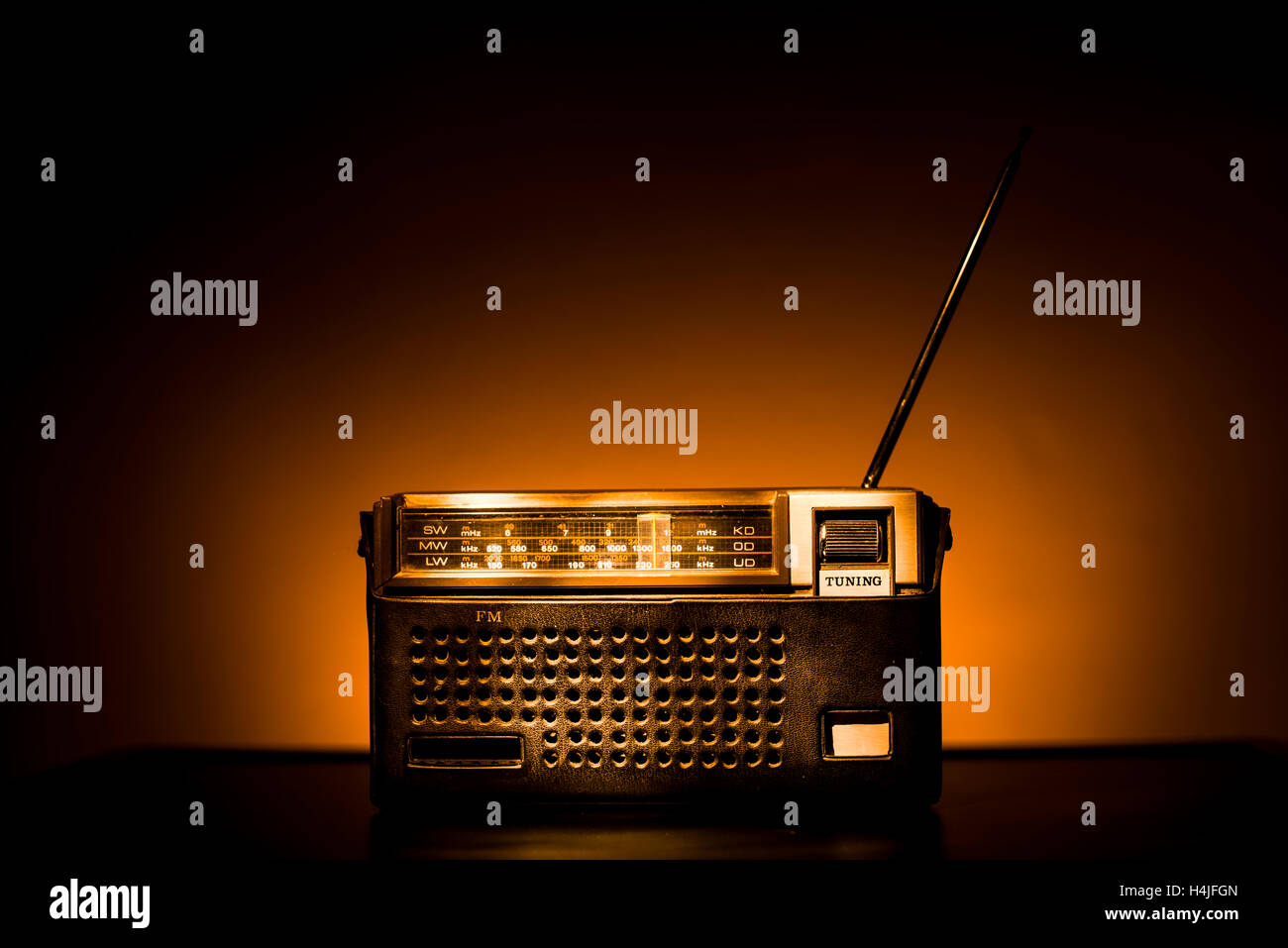 Old Fashion Brown Radio in a leather case on brown background. Stock Photo
