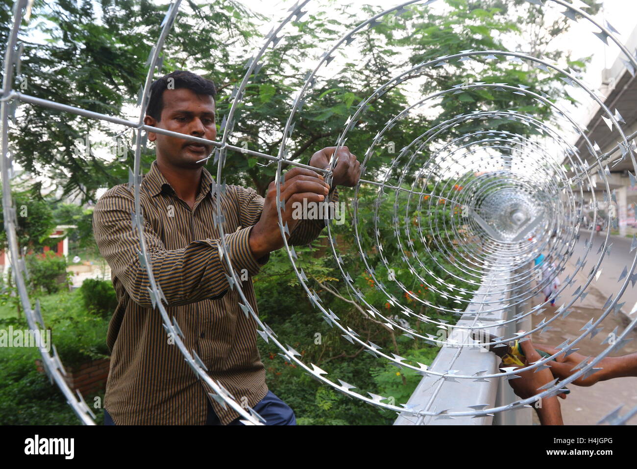 Being secured with razor wire on top of the iron fence in the capital ...