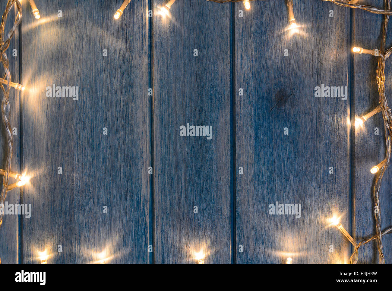 Christmas lights on wooden table Stock Photo - Alamy