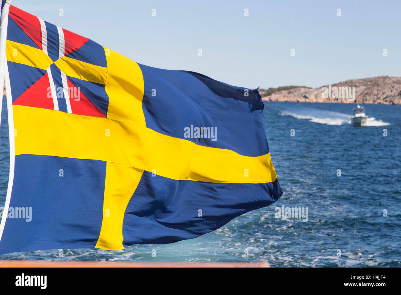 Flag of Sweden atop boat, Bohuslän, West Sweden, Sweden Stock Photo
