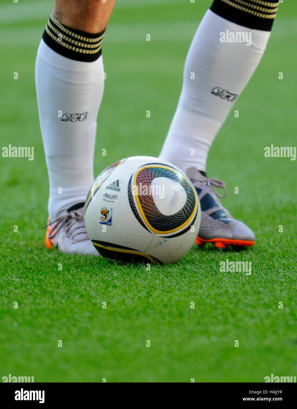 Footballers' legs with DFB Socks and adidas World Cup ball Jabulani Stock Photo